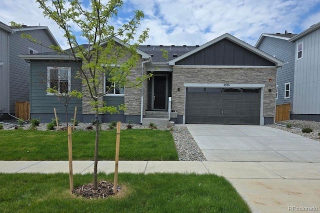 2536 Lupton Ln, Lafayette, CO 80026 - view of front of home with an attached garage, a front yard, and stone siding