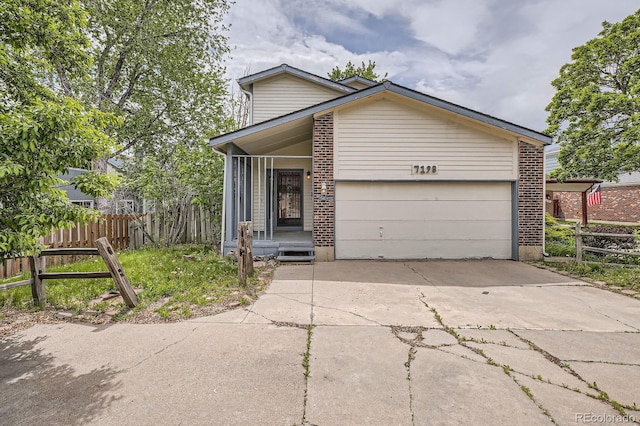 7198 Eaton Ct, Arvada, CO 80003 - view of front of home with brick siding, driveway, and a garage