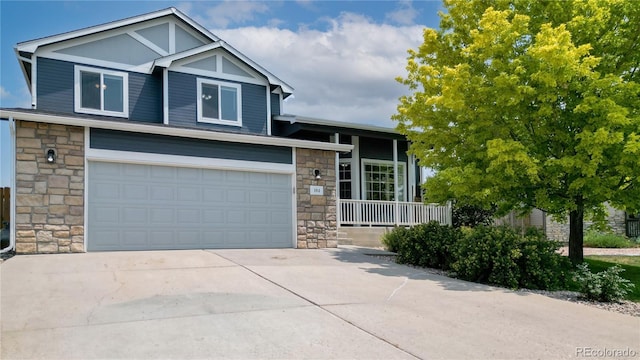 view of front of home with stone siding, concrete driveway, and an attached garage