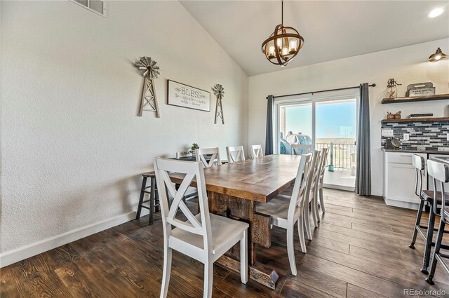 40051 Cold Iron Rd, Ramah, CO 80832 - dining space with lofted ceiling, a chandelier, dark wood-type flooring, and baseboards