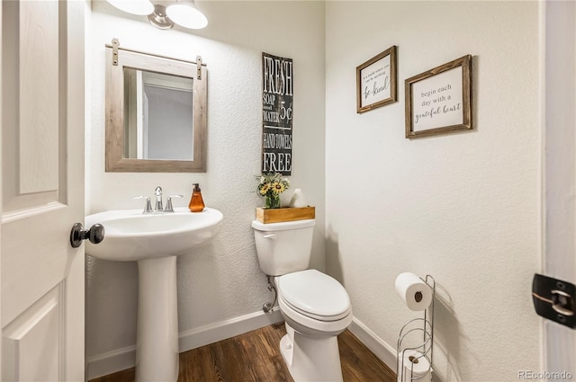 40051 Cold Iron Rd, Ramah, CO 80832 - bathroom featuring wood finished floors, toilet, and baseboards