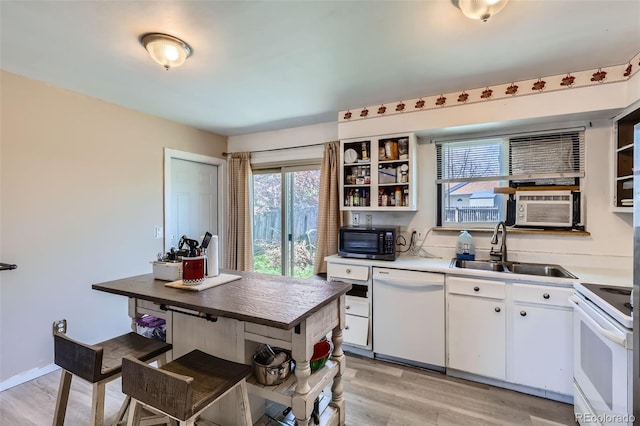 kitchen featuring open shelves, white appliances, light wood-style floors, white cabinets, and a sink