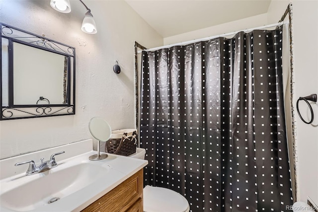 bathroom featuring vanity, toilet, and a shower with curtain