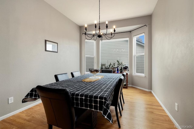 dining room with a chandelier and light hardwood / wood-style flooring