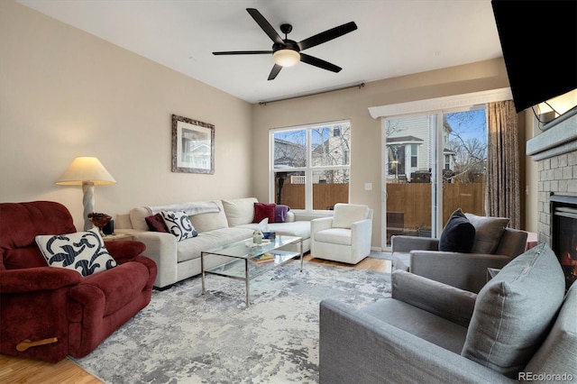 living room featuring light hardwood / wood-style flooring and ceiling fan