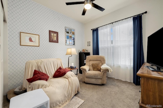 sitting room featuring ceiling fan and light carpet