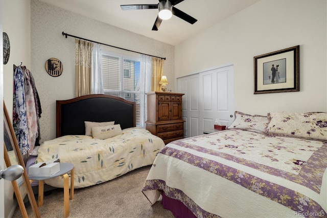 carpeted bedroom featuring ceiling fan and a closet