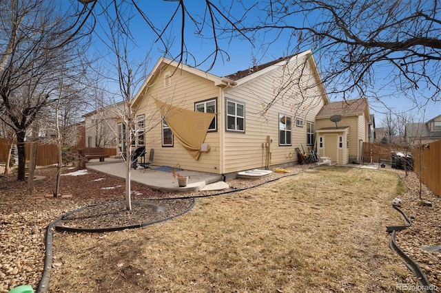 back of house featuring a lawn and a patio area