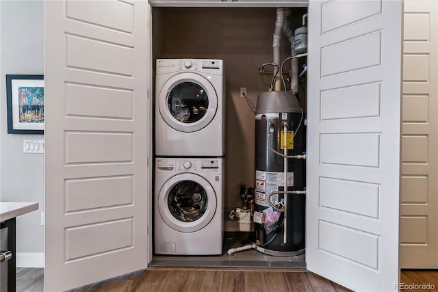 washroom featuring secured water heater, dark hardwood / wood-style flooring, and stacked washer / drying machine