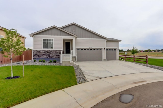 craftsman-style home featuring a front lawn and a garage