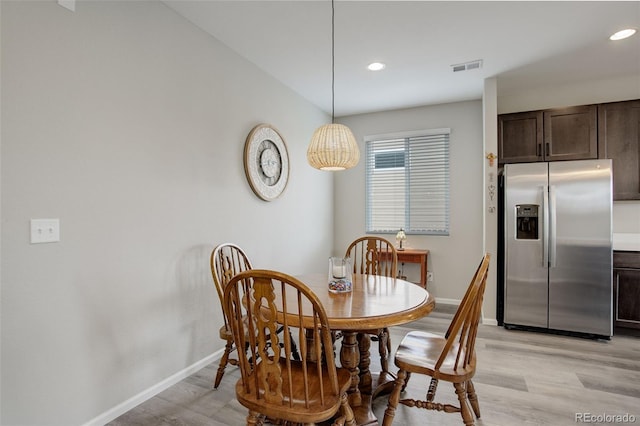 dining area featuring light wood-type flooring