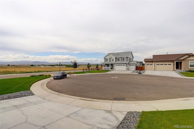 exterior space with a mountain view and a front lawn