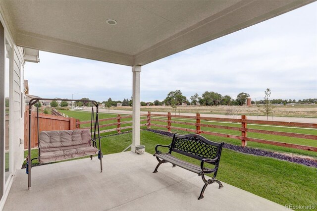 exterior space with a yard, a rural view, and a patio