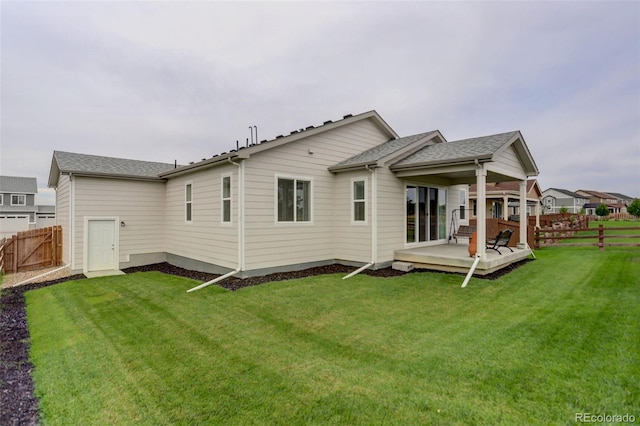 rear view of house featuring a lawn