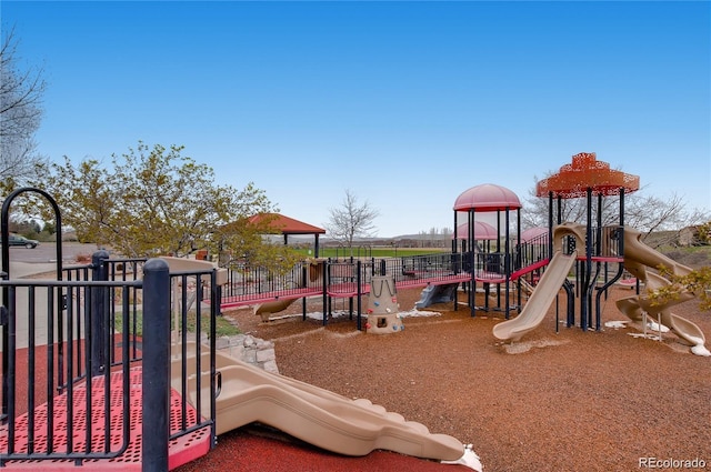 community jungle gym featuring fence
