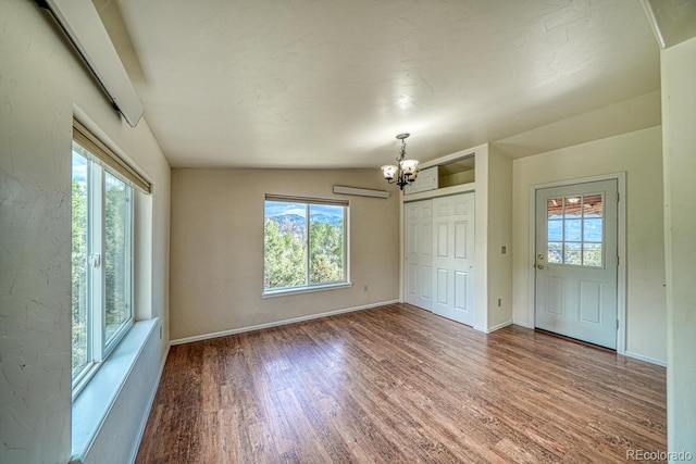 236 Boreen Way, Howard, CO 81233 - interior space featuring a chandelier, wood finished floors, baseboards, and a wall mounted AC
