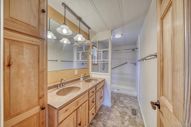 236 Boreen Way, Howard, CO 81233 - bathroom featuring a textured ceiling, a walk in shower, double vanity, and toilet