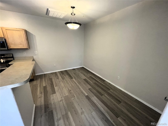 unfurnished dining area with visible vents, baseboards, and dark wood-style flooring