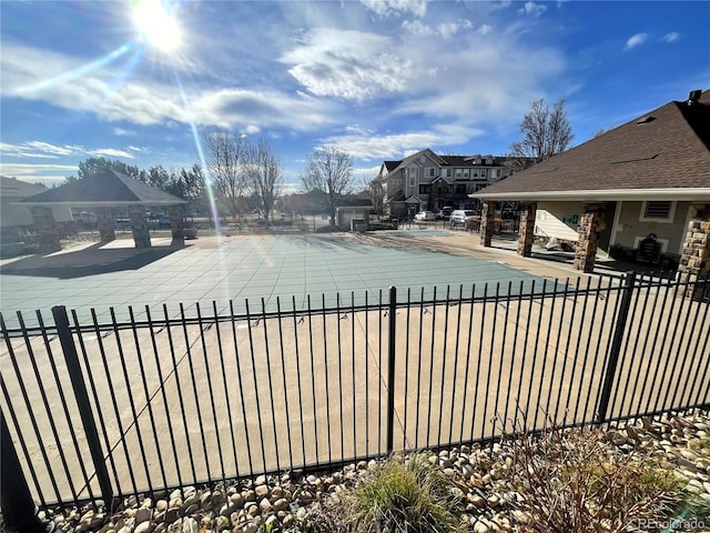 pool with a residential view, fence, and a patio area