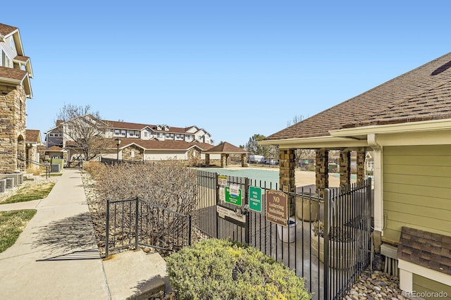 exterior space with a residential view and fence