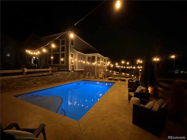 pool at night with a patio