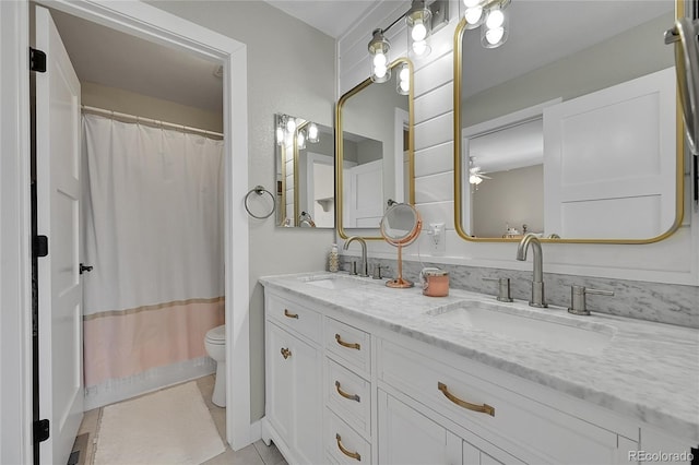 bathroom with a shower with curtain, tile patterned floors, toilet, and vanity