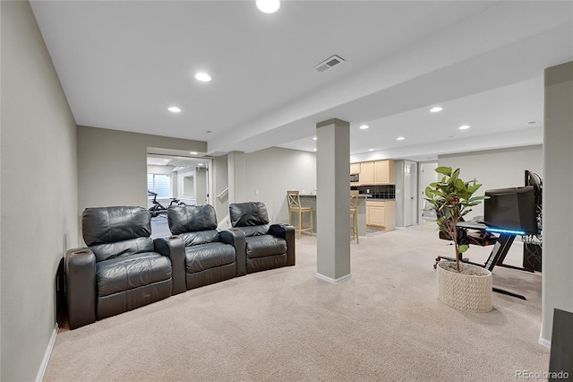 cinema room featuring light colored carpet