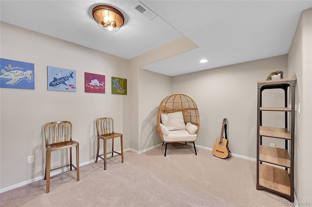 living area featuring carpet