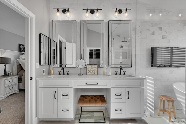 full bathroom with a sink, double vanity, tile walls, and a tile shower