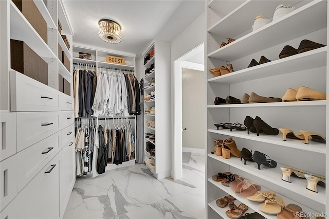 spacious closet featuring marble finish floor