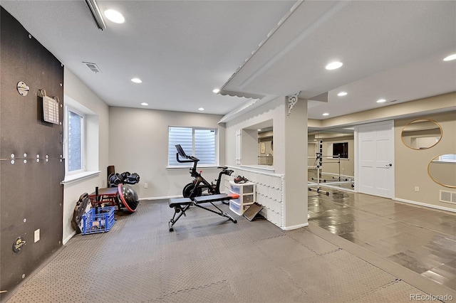 exercise area with visible vents, baseboards, and recessed lighting