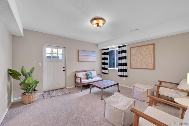 living area featuring carpet floors and baseboards