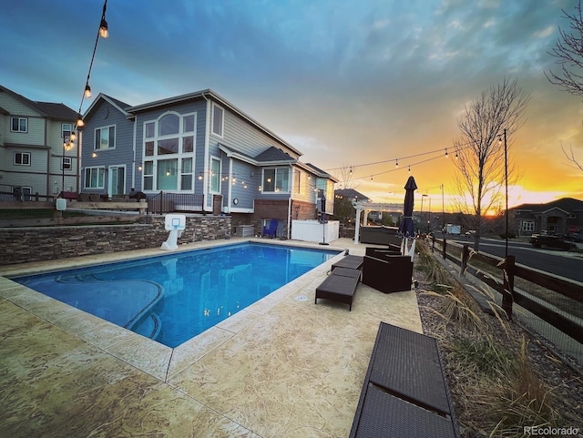 view of pool featuring a patio area, fence, and a fenced in pool