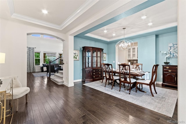 19894 W 94th Ln, Arvada, CO 80007 - dining room with a tray ceiling, arched walkways, crown molding, dark wood-type flooring, and recessed lighting