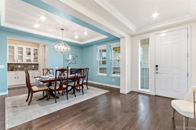 19894 W 94th Ln, Arvada, CO 80007 - dining room featuring a tray ceiling, dark wood-style floors, crown molding, a chandelier, and recessed lighting