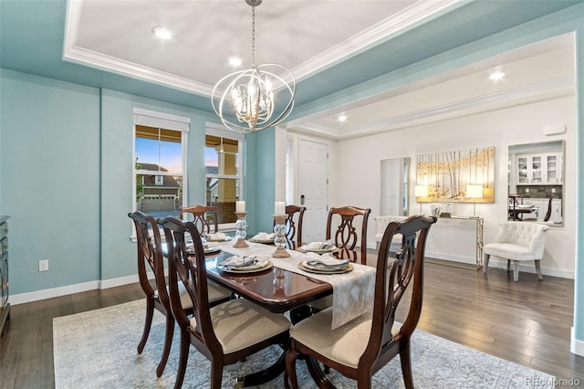 19894 W 94th Ln, Arvada, CO 80007 - dining space with ornamental molding, a chandelier, a tray ceiling, dark wood-style floors, and recessed lighting