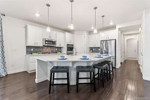 19894 W 94th Ln, Arvada, CO 80007 - kitchen featuring appliances with stainless steel finishes, white cabinets, tasteful backsplash, recessed lighting, and dark wood-style flooring