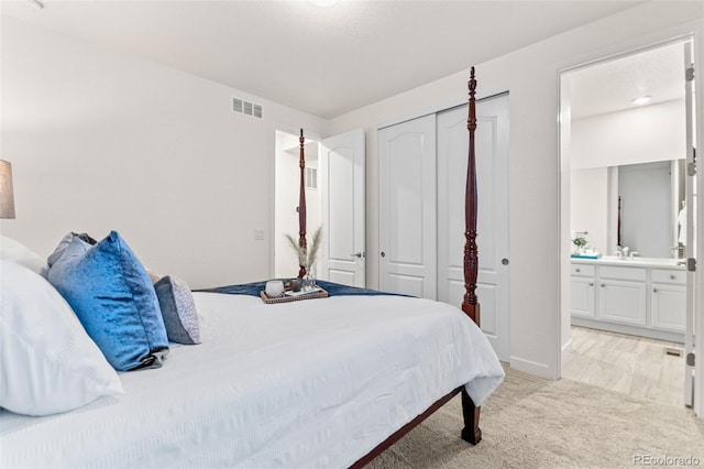 19894 W 94th Ln, Arvada, CO 80007 - bedroom with light colored carpet, a closet, and connected bathroom