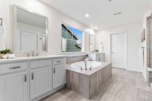 19894 W 94th Ln, Arvada, CO 80007 - bathroom featuring two vanities and a bath