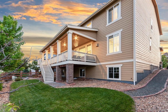 19894 W 94th Ln, Arvada, CO 80007 - back of property featuring a lawn, stairs, and a wooden deck