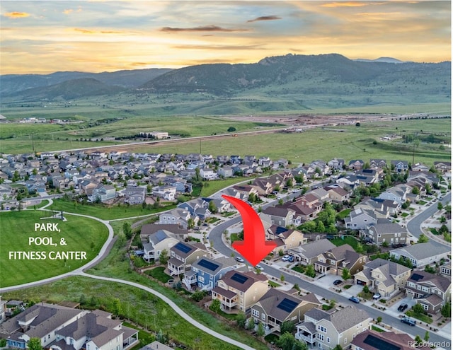 19894 W 94th Ln, Arvada, CO 80007 - aerial view of property's location with a mountainous background and nearby suburban area