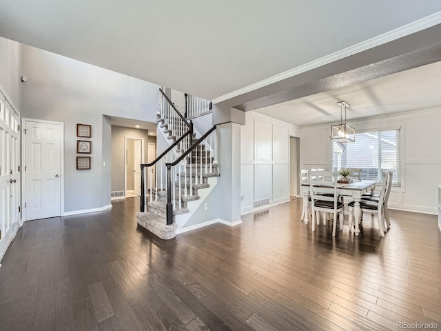 dining area with dark hardwood / wood-style floors and crown molding