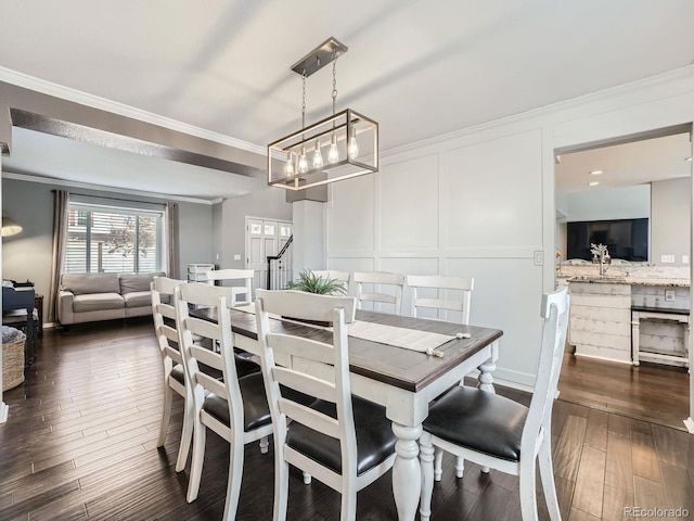 dining space with ornamental molding and dark wood-type flooring