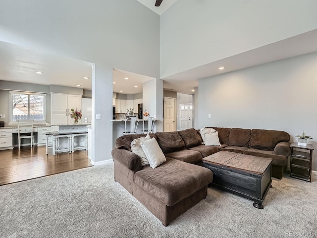 living room with wood-type flooring and a high ceiling