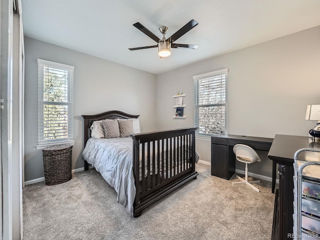 carpeted bedroom with multiple windows and ceiling fan