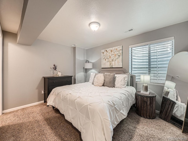 carpeted bedroom featuring a textured ceiling