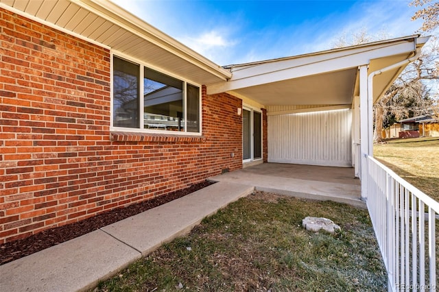 doorway to property with brick siding