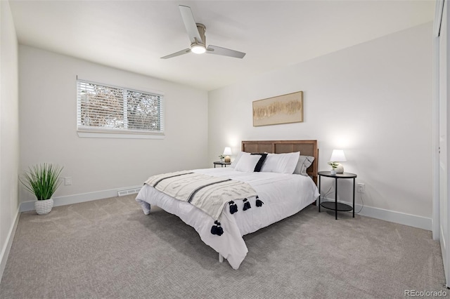 bedroom featuring baseboards, carpet floors, visible vents, and ceiling fan