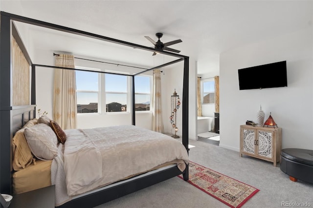 carpeted bedroom with ensuite bathroom and ceiling fan