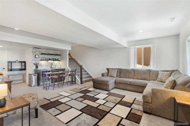 living room with light carpet and bar area